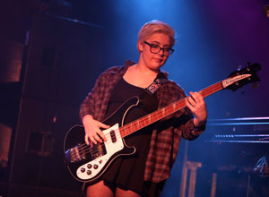 Izzi Sneider, 16, plays the bass during a performance with School of Rock. (Photo by Tim Hawk)