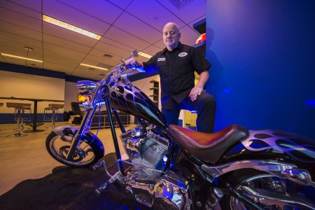 Kjell Hegstad parks his customized motorcycle inside 1313. Digital Vikings, his mobile design and development business, is a primary user of the facility.