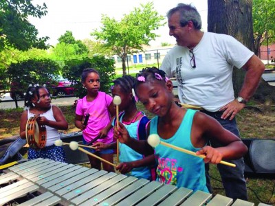 Children enjoy playing the vibraphone with Philly Vibe Duo and Harvey Price at Holloway Park. (Photo courtesy of The Grand Opera House)