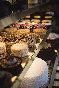 Assorted tarts and cakes crowd the display case. 