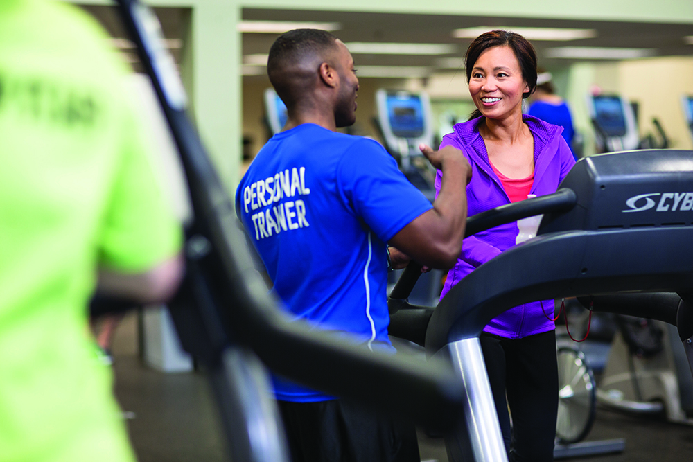 A personal trainer at the YMCA coaches a client on the treadmill. (Photo courtesy of the YMCA)