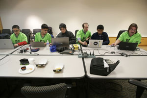 Members of the program team work on the autonomous program, which will allow the robot "ToMOEhawk" to run 15 seconds by itself. (Photo by Tim Hawk)