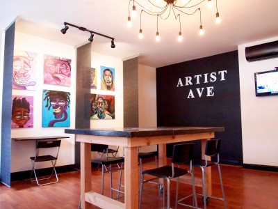 Artist Ave Station features a ground-level co-working area that doubles as an art gallery.